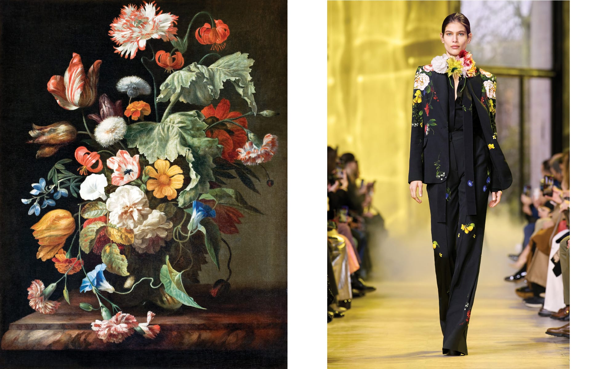 Vibrant floral still life painting next to a model in a flower-embroidered black suit on the runway.