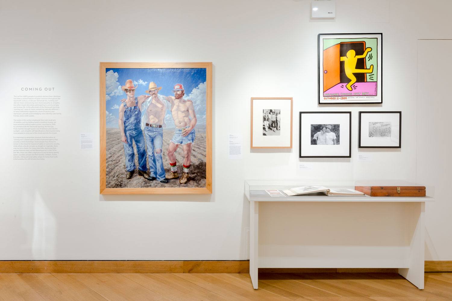 Art gallery wall showcasing diverse framed artworks and photographs, including paintings and sketches.