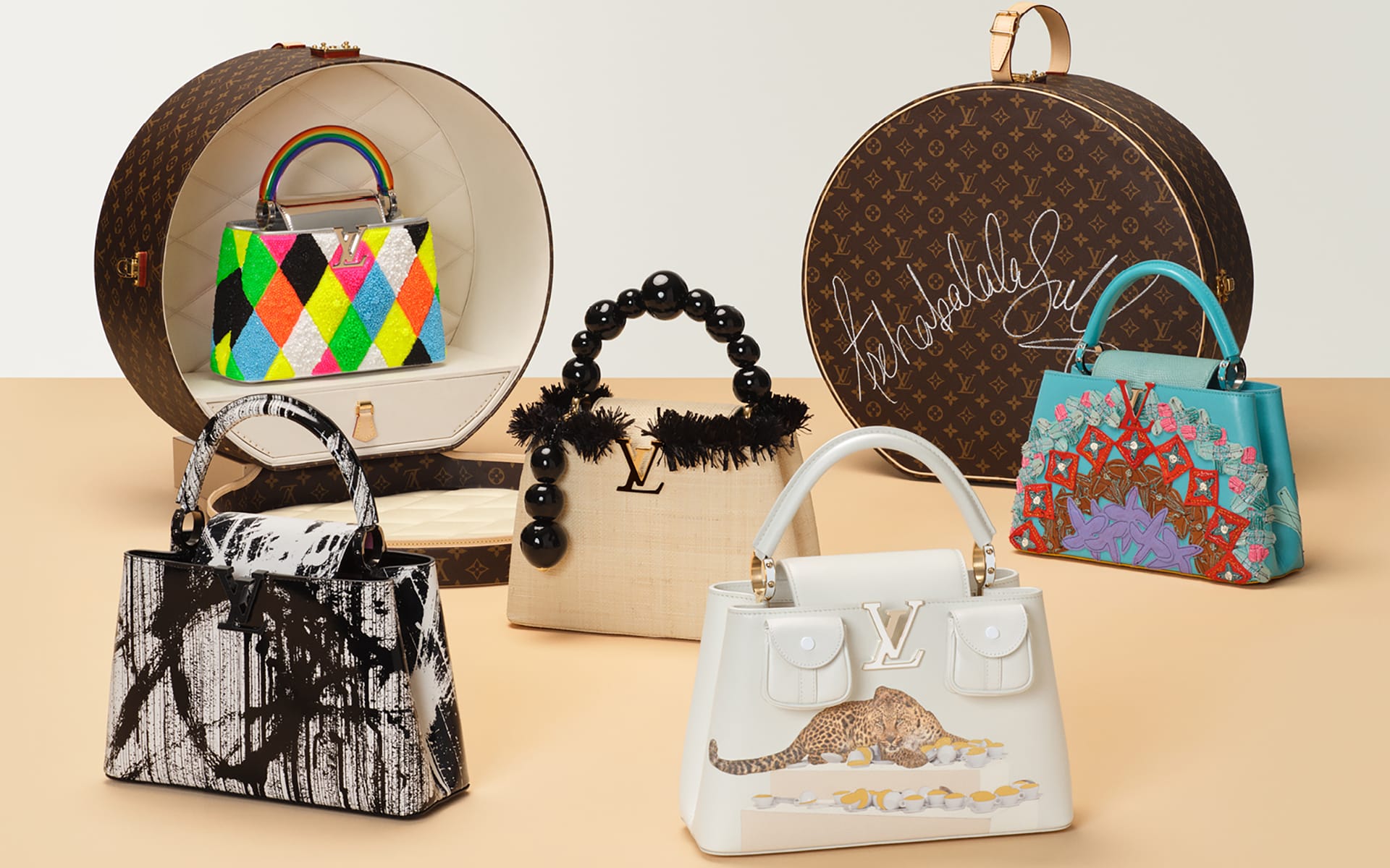 Assorted luxury handbags in various colors and designs arranged on a beige background.