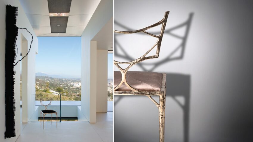 Modern interior with abstract chair and wide window view of a cityscape.