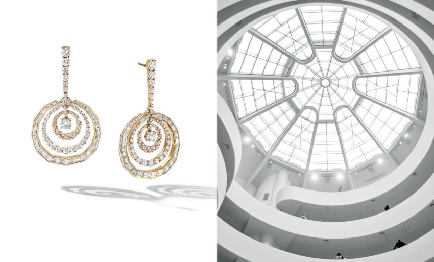 Gold and diamond chandelier earrings alongside architectural view of a spiraling building interior with glass dome ceiling.