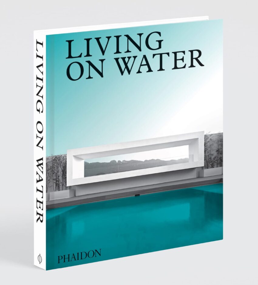 Cover of the book "Living on Water" featuring modern architecture over a blue pool with mountains in the background.