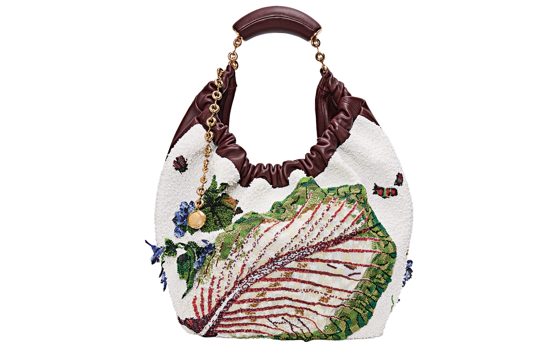 White bag with brown handle adorned with embroidered leaves and flowers.