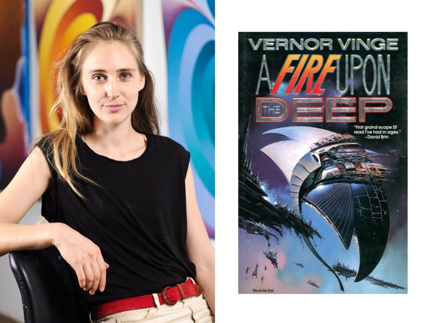 Person sitting beside "A Fire Upon the Deep" book cover, showing a futuristic spaceship with vibrant artwork in the background.