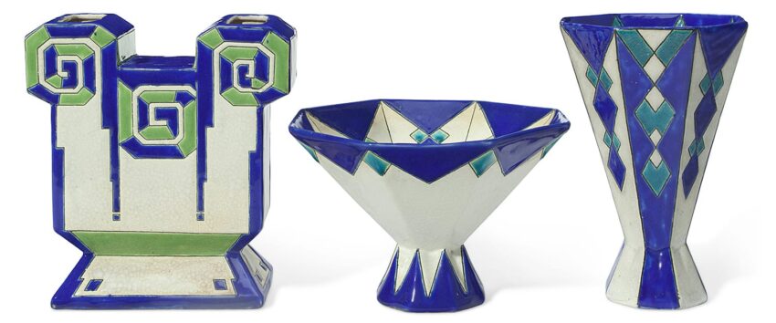 Three Art Deco ceramic vases with geometric designs in blue, green, and white, featuring bold shapes and intricate patterns.