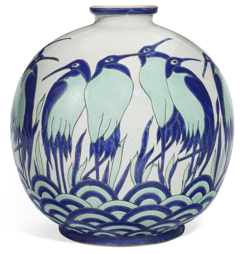 Ceramic vase with blue and green herons standing amidst stylized waves and reeds, showcasing intricate detailing.