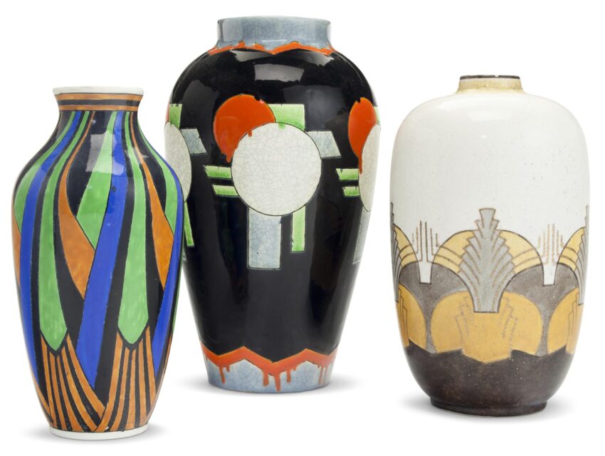 Three colorful Art Deco ceramic vases with geometric patterns and bold designs displayed against a white background.