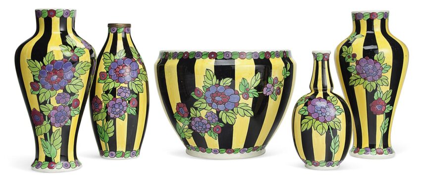 Art Deco ceramic vases and bowl with black and yellow stripes, adorned with purple flowers and green leaves.