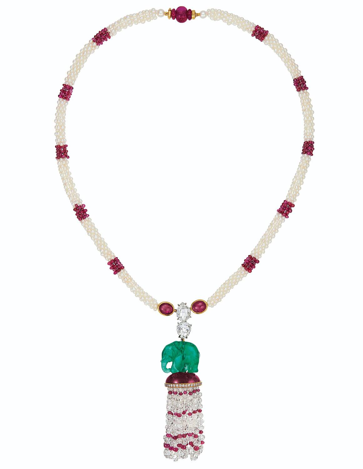 Elegant pearl and ruby bead necklace with emerald and diamond encrusted elephant pendant.