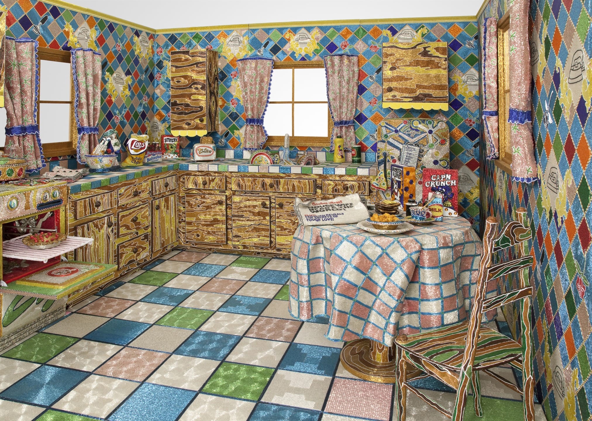 Colorful kitchen with patterned tiles and mosaic decor, featuring a table with breakfast items and various kitchen appliances.