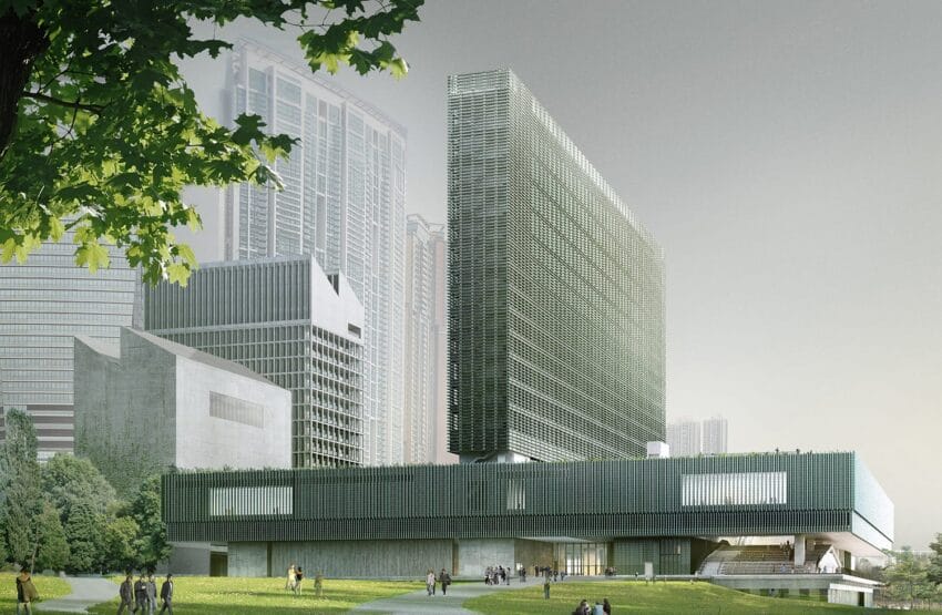 Modern green building with a unique facade surrounded by skyscrapers and trees, people walking nearby on a sunny day.