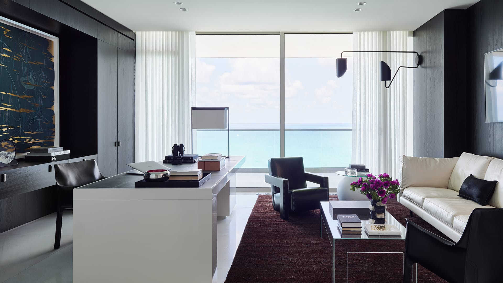 Modern living room with ocean view, contemporary furniture, large window, and minimalist decor.