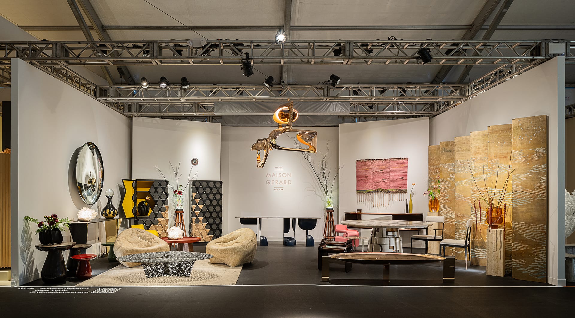 Modern furniture showroom with unique designs, including chairs, tables, and decorative art pieces in an exhibition space.