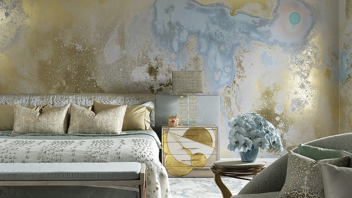 Luxurious bedroom with abstract painted wall, elegant bed, gold accents, and a cozy chair.