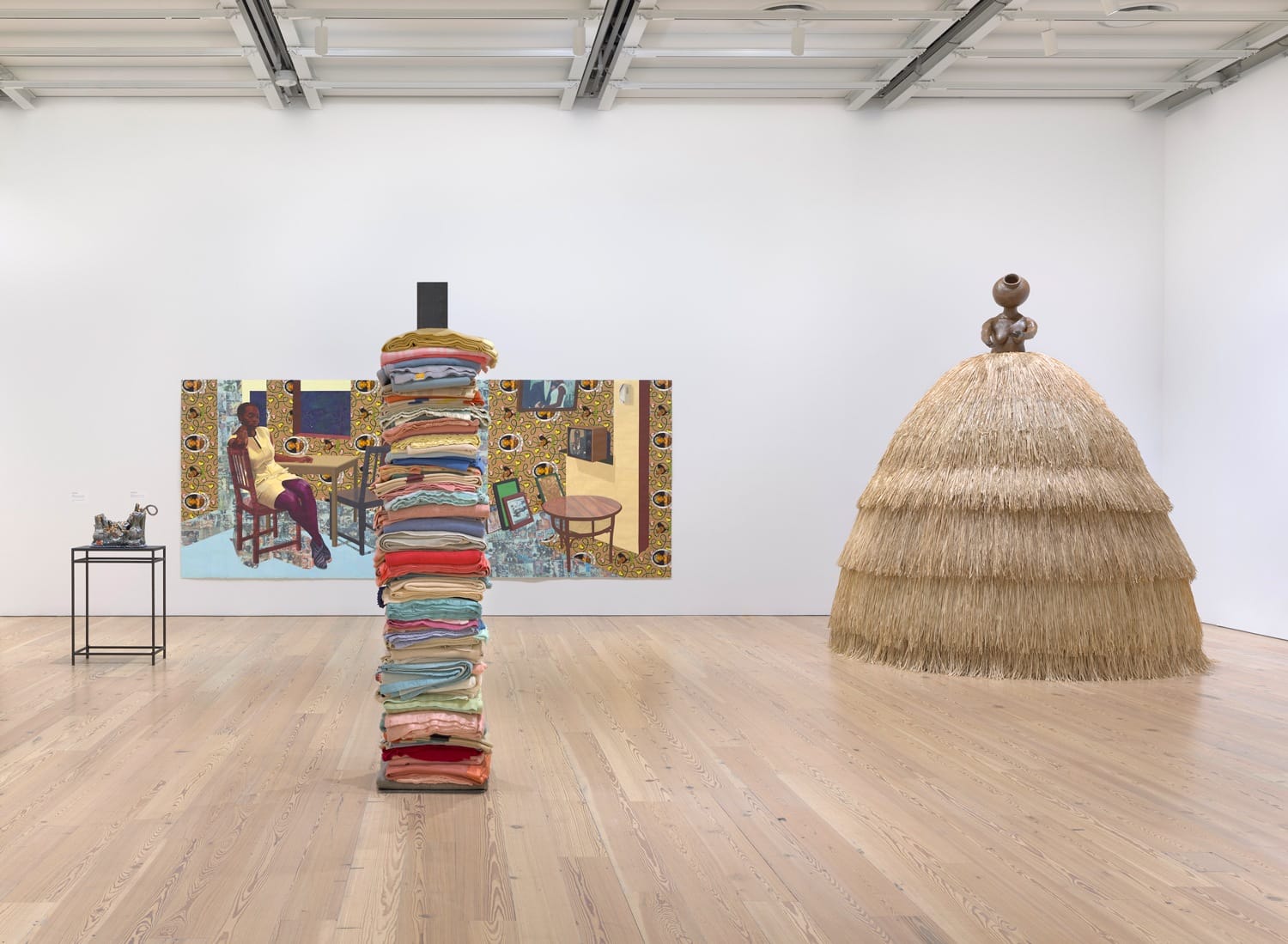 Installation view of Making Knowing: Craft in Art, 1950-2019 (Whitney Museum of American Art, New York, November 22, 2019-January 2021). From left to right: Kahlil Robert Irving, 100’s, 2018; Njideka Akunyili Crosby, Portals, 2016; Marie Watt, Skywalker/Skyscraper (Axis Mundi), 2012; Simone Leigh, Cupboard VIII, 2018.
