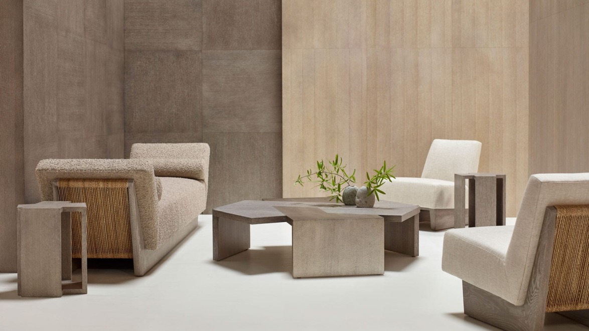Modern minimalist living room with beige sofas, wooden coffee table, and potted plant on light wood flooring.