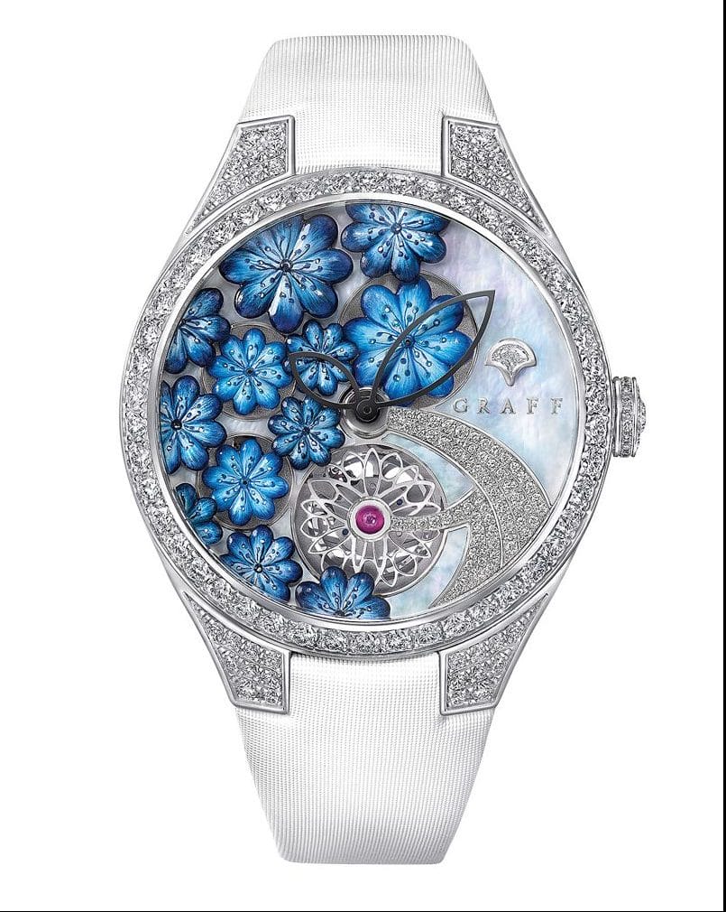 Luxury wristwatch with blue floral design, diamond accents, and a silver band.