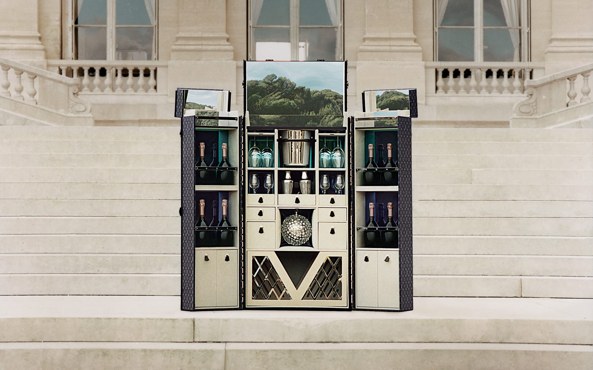 Lined in Monogram Eclipse canvas, the Louis Vuitton Party trunk stores up to 30 bottles as well as glassware and barware; a mirrored top, colored plexiglass panels, and a disco ball etched with LV logos add to the joi de vivre.