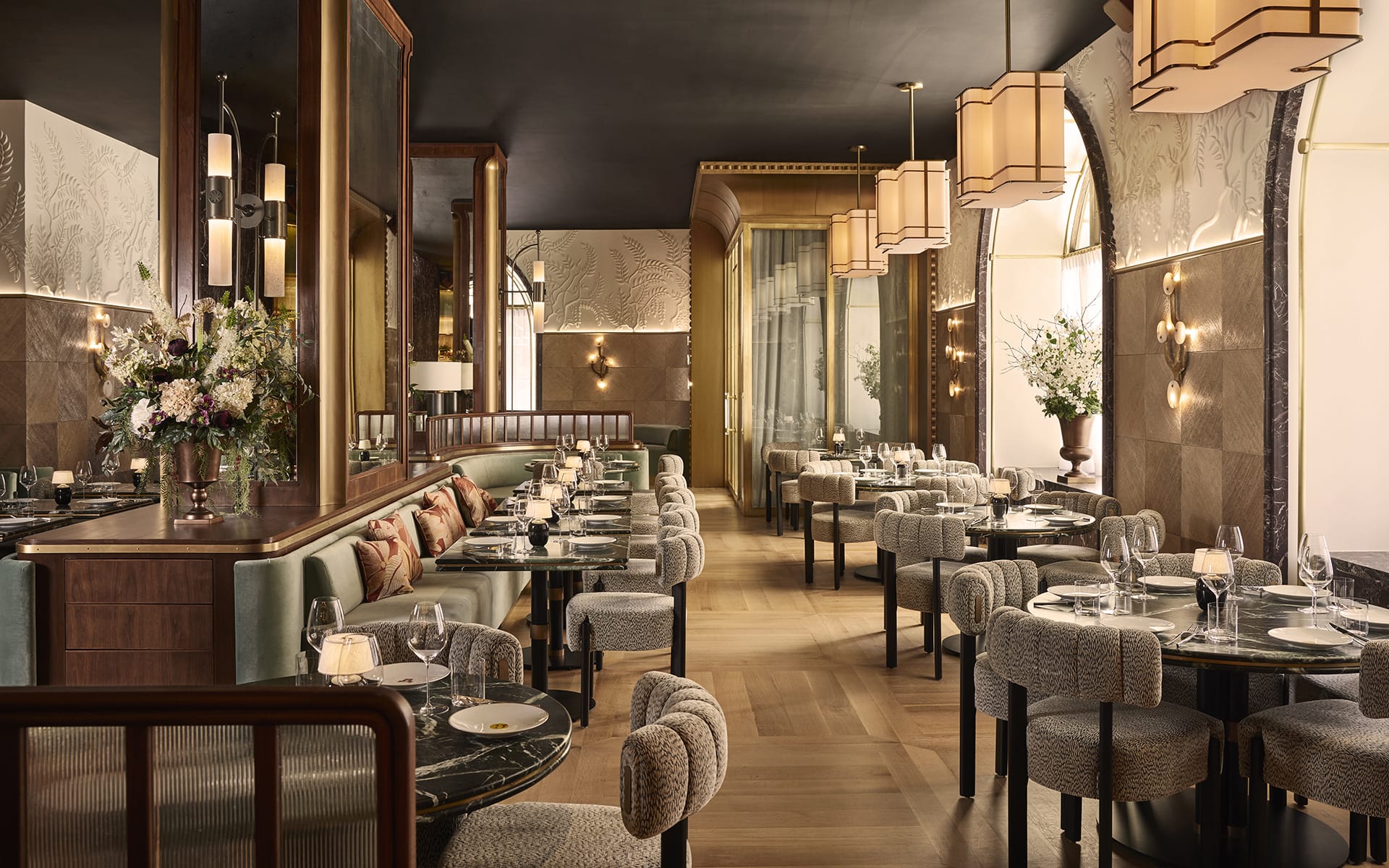 Elegant restaurant interior with modern decor, stylish lighting, and neatly arranged tables set for dining.