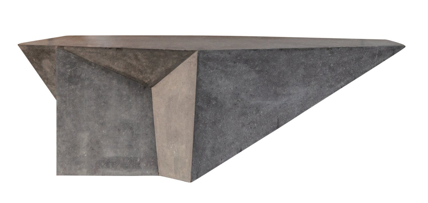 Modern geometric concrete table with angular shapes and smooth surfaces.