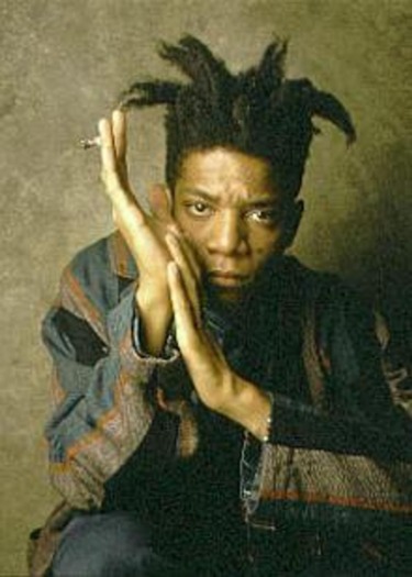 A person with unique hairstyle holding hands together in a contemplative pose against a textured background.