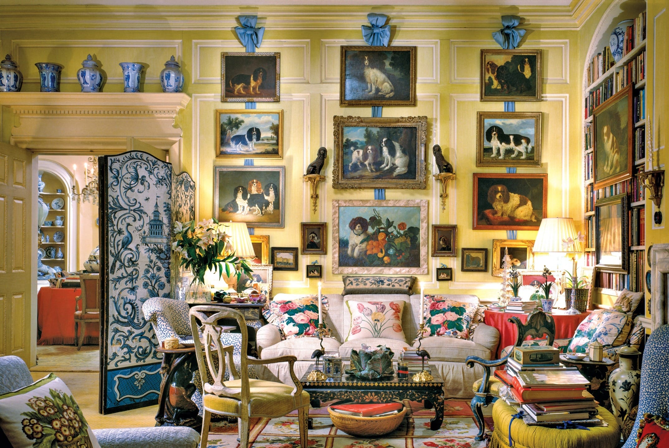 Elegant living room with classic decor, floral patterns, numerous dog paintings, and a variety of decorative vases on display.