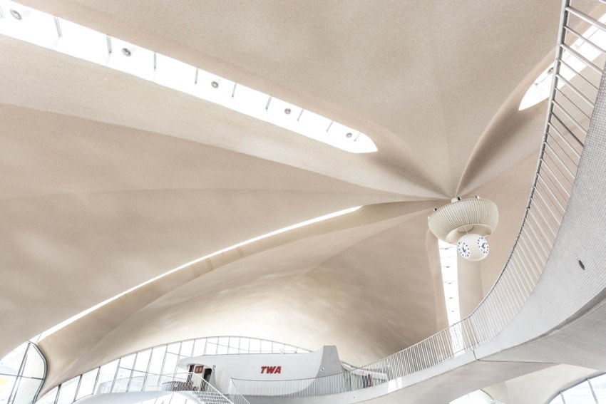 Interior view of the TWA terminal with its iconic sweeping ceiling, designed by Eero Saarinen, showcasing modern architectural style.
