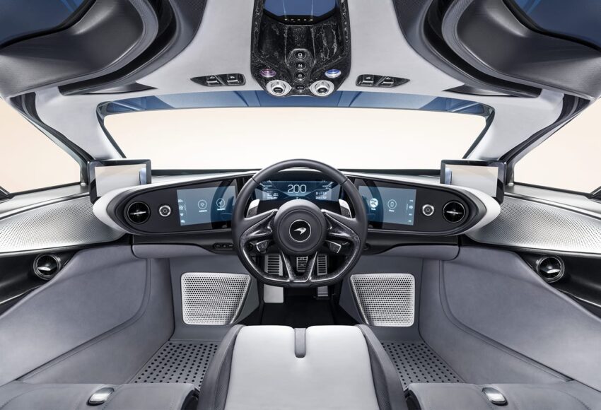Futuristic car interior with a sleek dashboard, three digital screens, and modern steering wheel design.