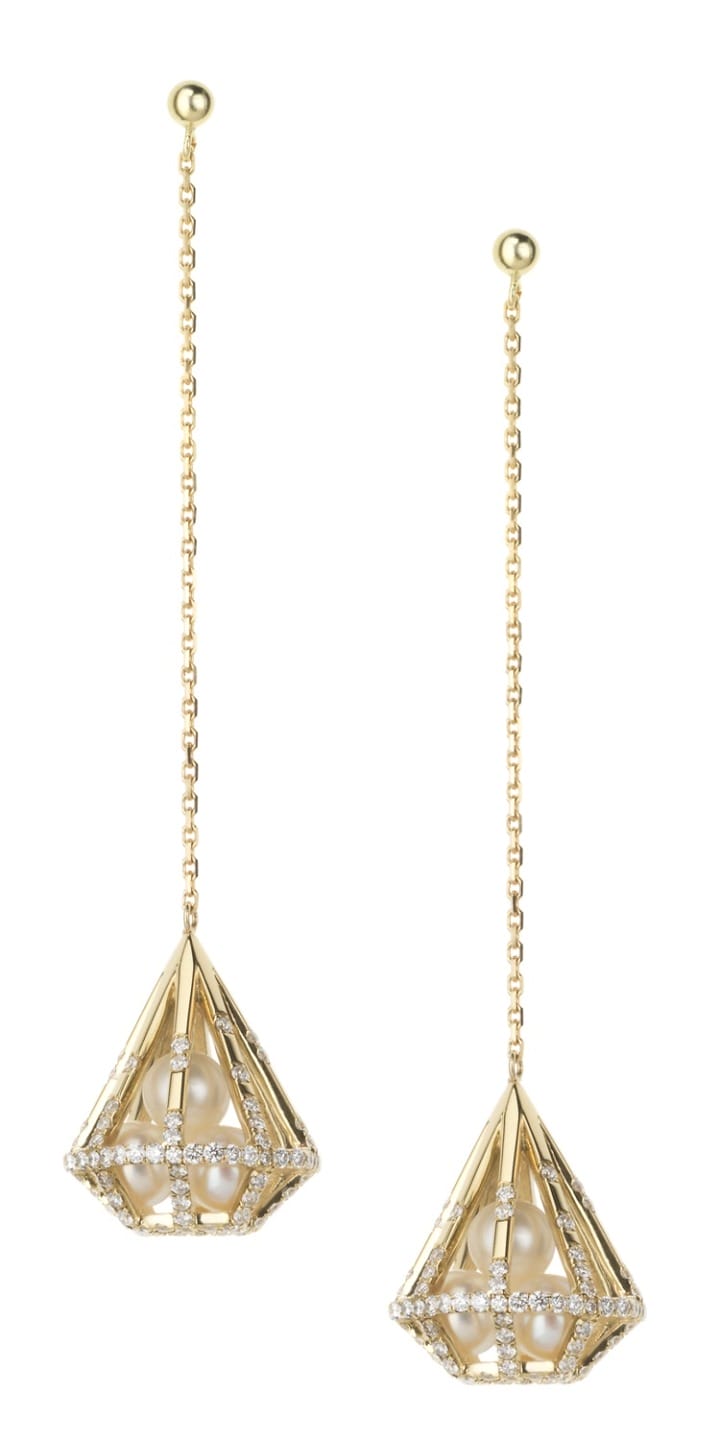 Gold geometric drop earrings with diamond accents and chain design, hanging from round studs.