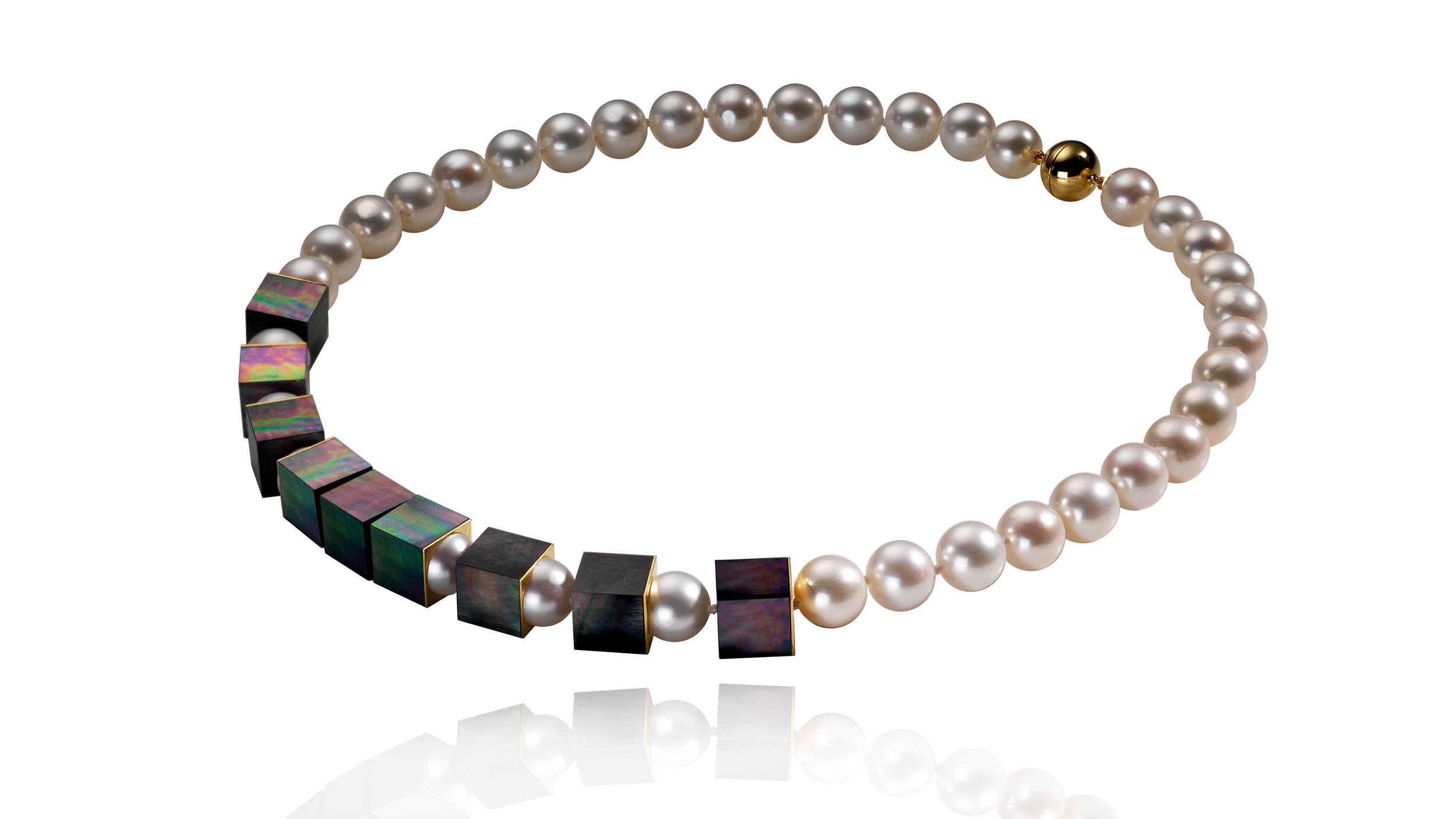Pearl necklace with black cubic accents and a single gold bead on a white background.
