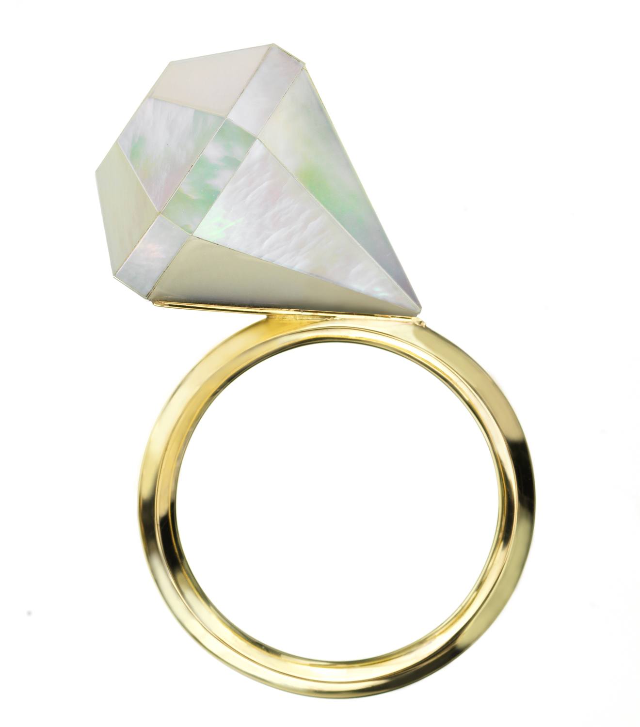 Gold ring with a large, geometrically shaped, translucent stone set vertically.