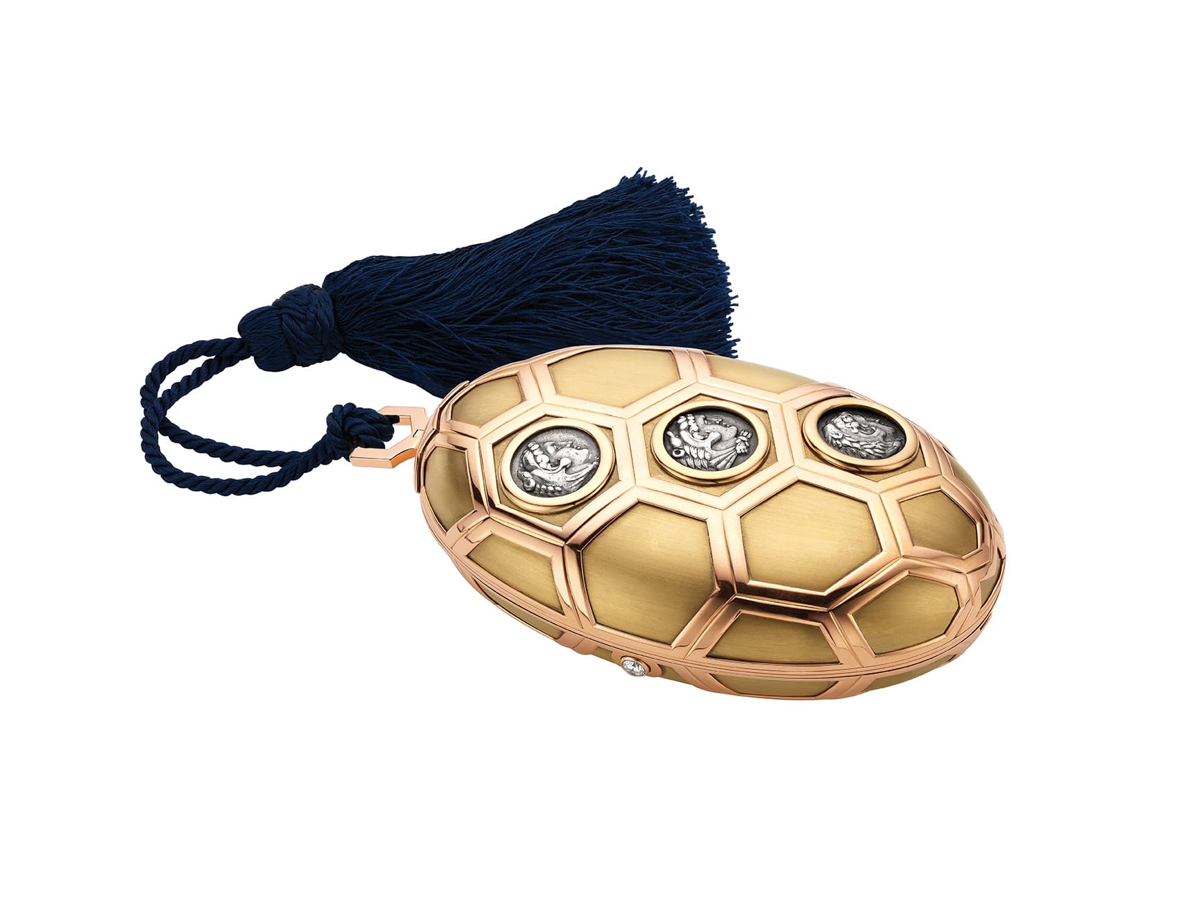 Gold and rose gold egg-shaped jewelry box with blue tassel and ornate silver accents.