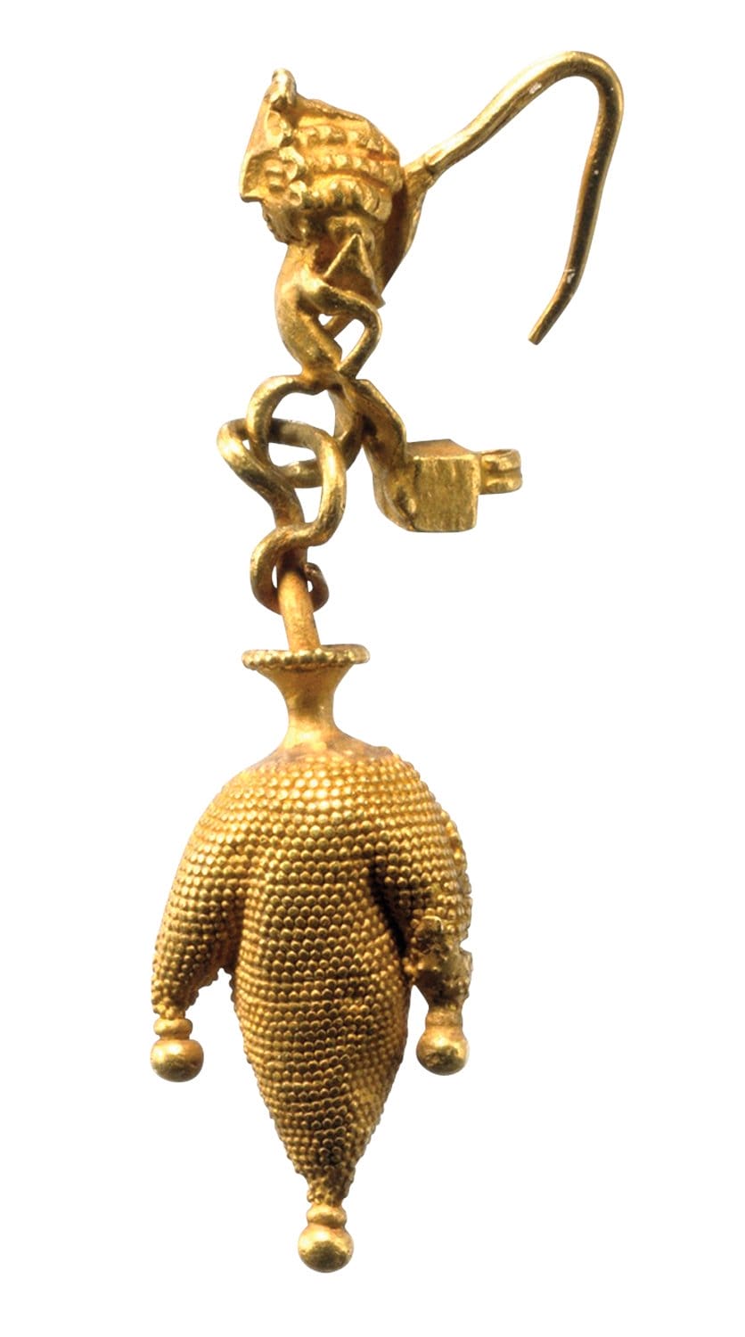 Ancient gold earring featuring intricate design with a dangling, textured pendant and hook.