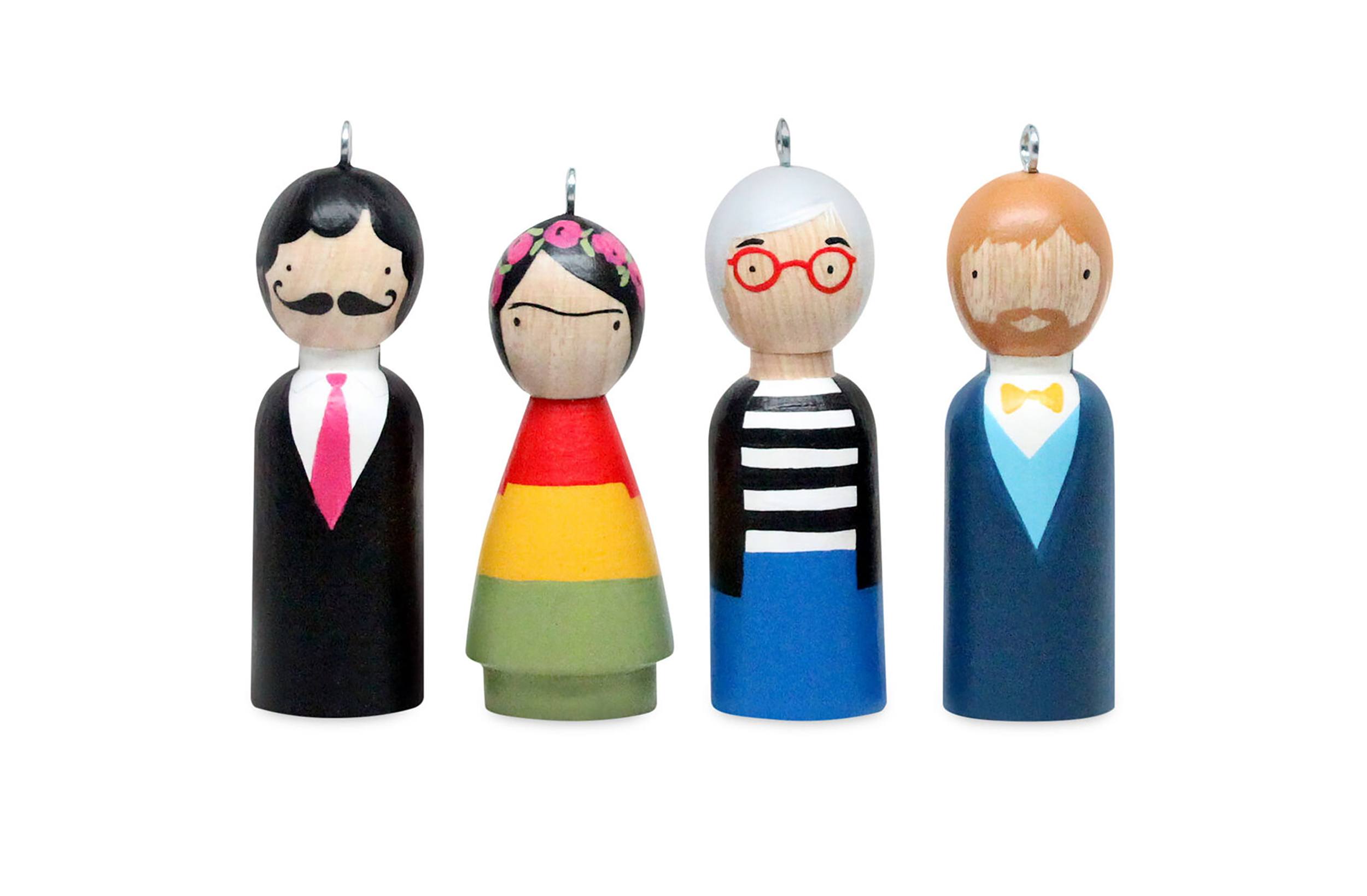 Wooden peg dolls painted as unique characters, each with distinct clothing and hairstyles, standing side by side.