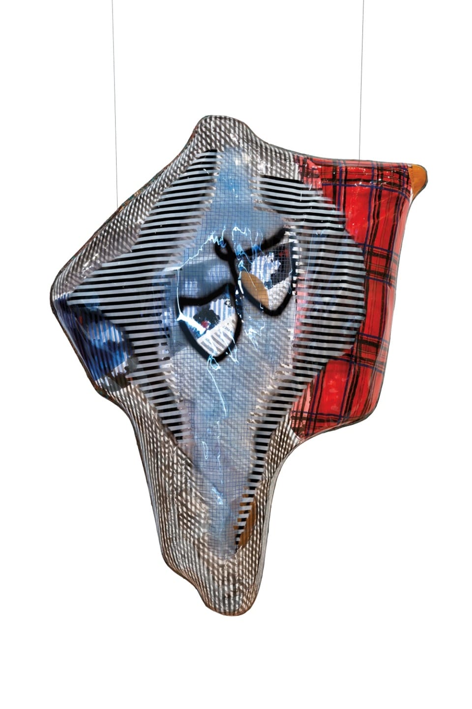 Abstract plaid and striped fabric sculpture with blue and red tones suspended against a white background