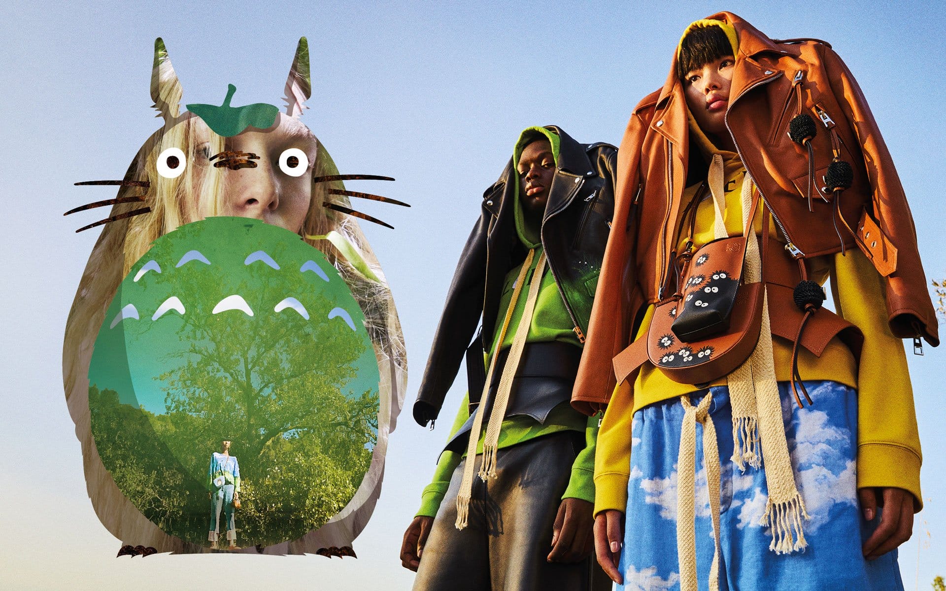 Surreal fashion scene with giant cartoon creature and two models wearing layered colorful jackets against a clear sky.
