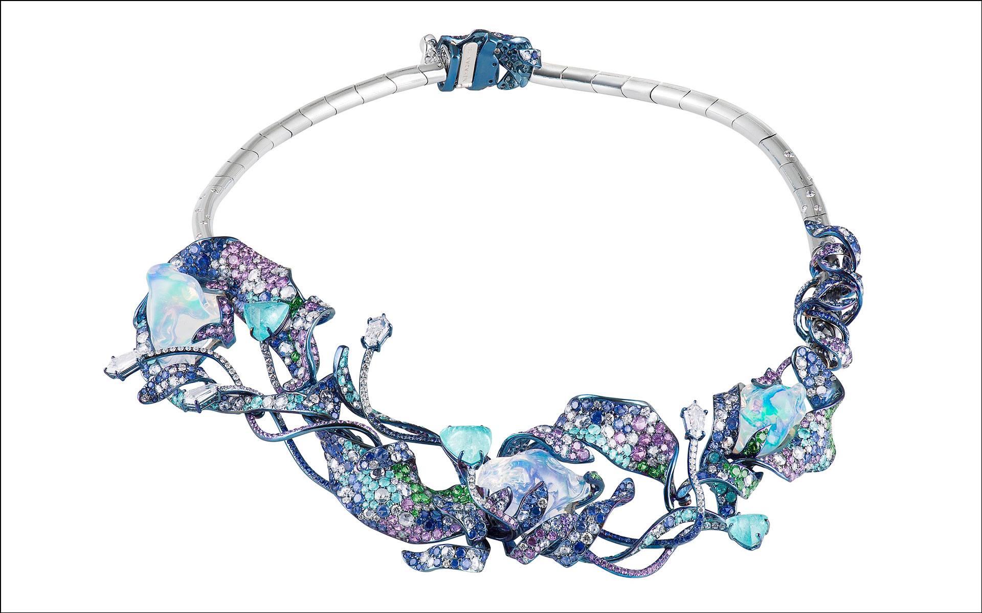 Elegant necklace with intricate blue and purple gemstone design, featuring unique swirling and angular shapes.