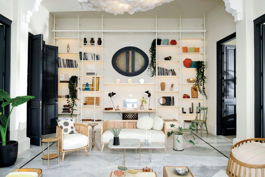 Modern living room with stylish furniture, open shelves, and decorative plants, creating a cozy and elegant atmosphere.