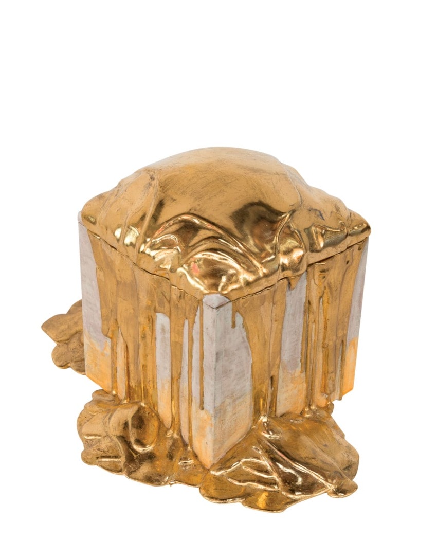 Gold melted over a silver cube, resembling a melting effect, isolated on a white background.