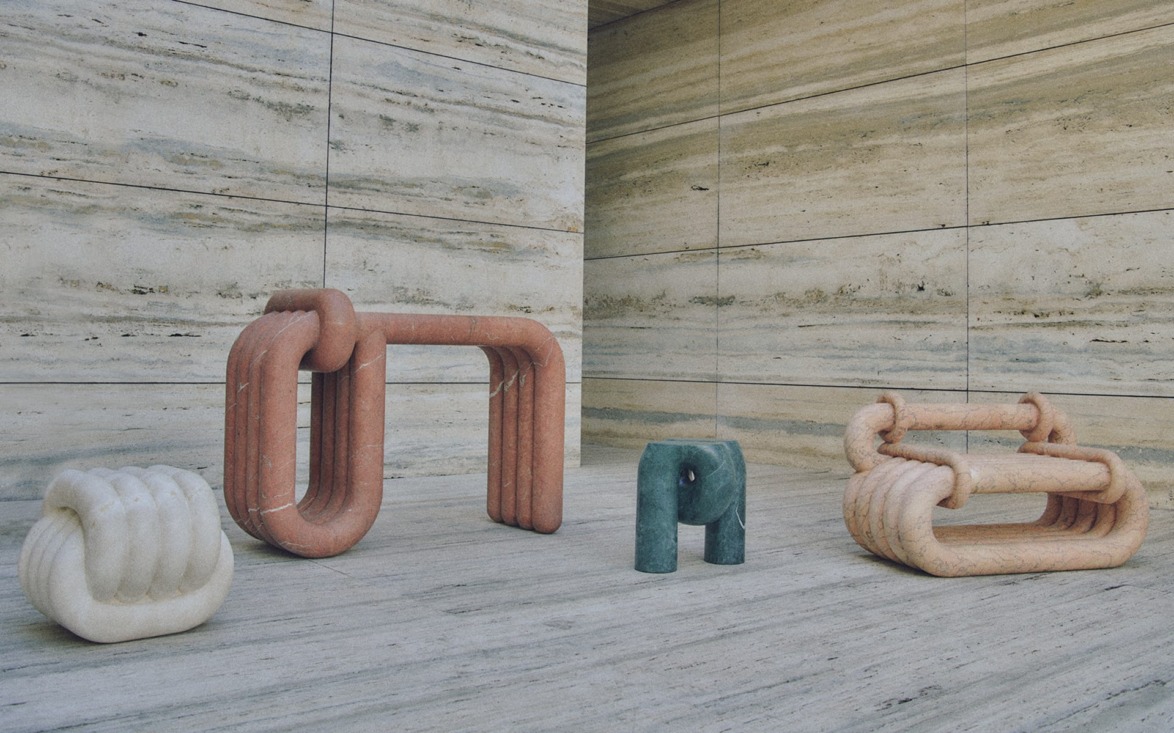 Modern abstract sculptures in a minimalist gallery setting with textured stone walls