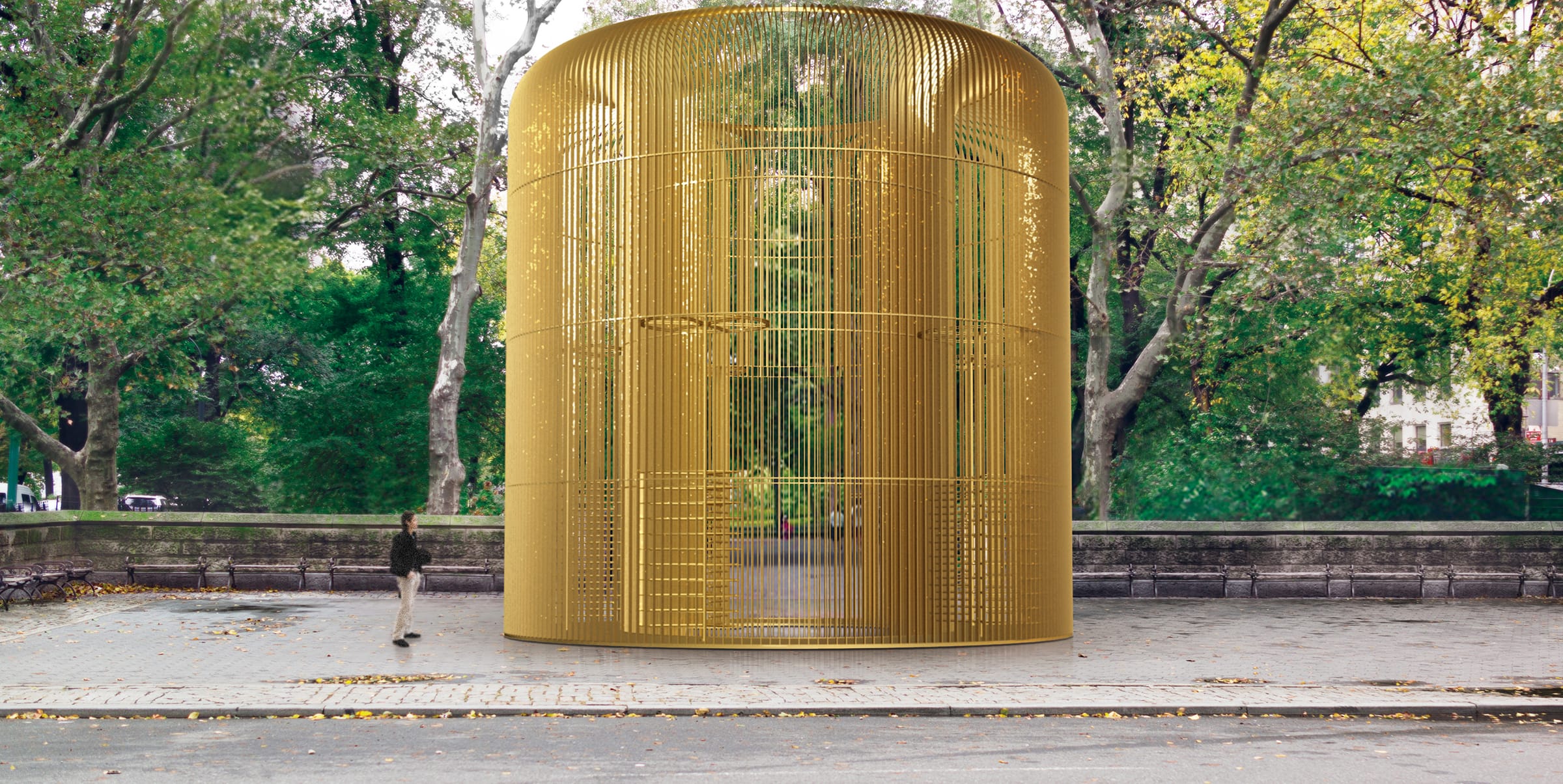 Large golden cage sculpture in a park setting with trees and person walking nearby.