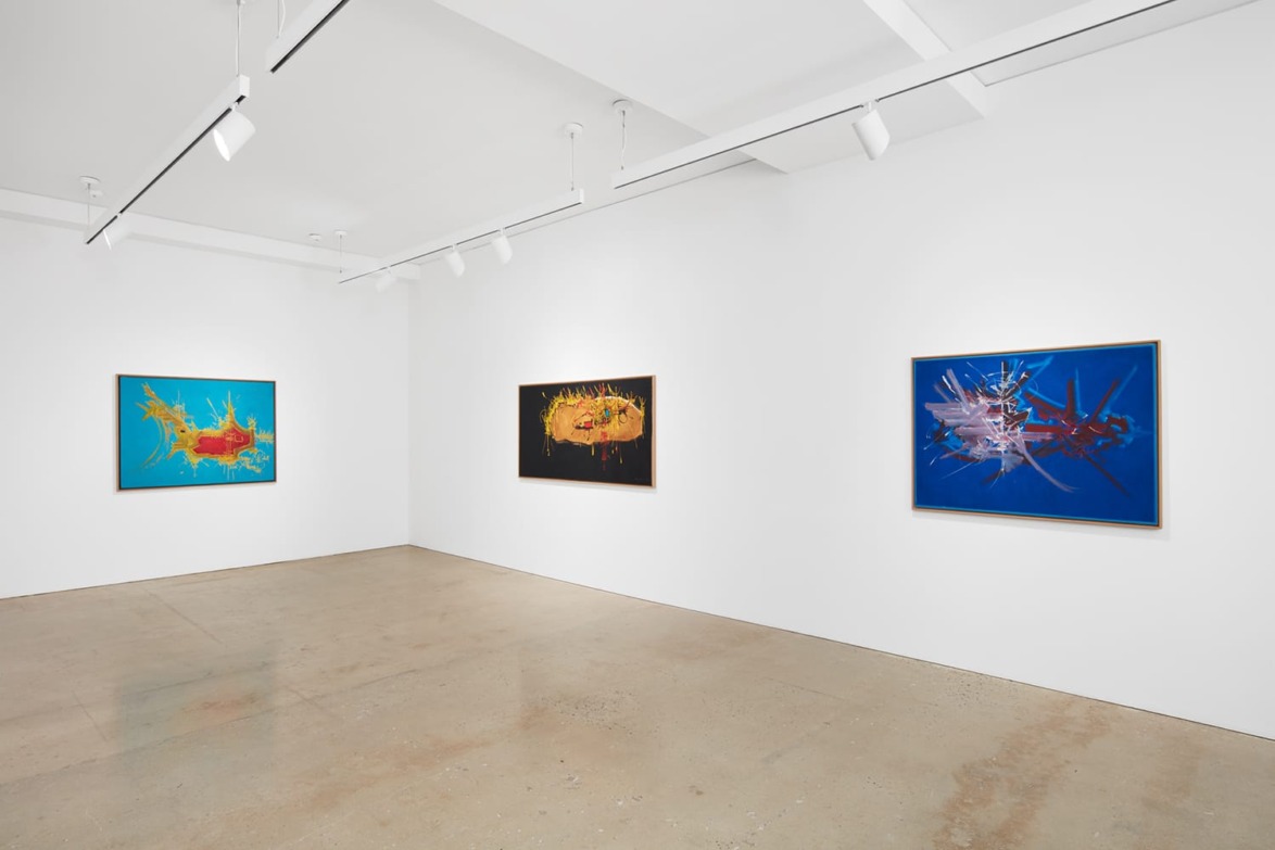 Modern art gallery with three abstract paintings displayed on white walls.