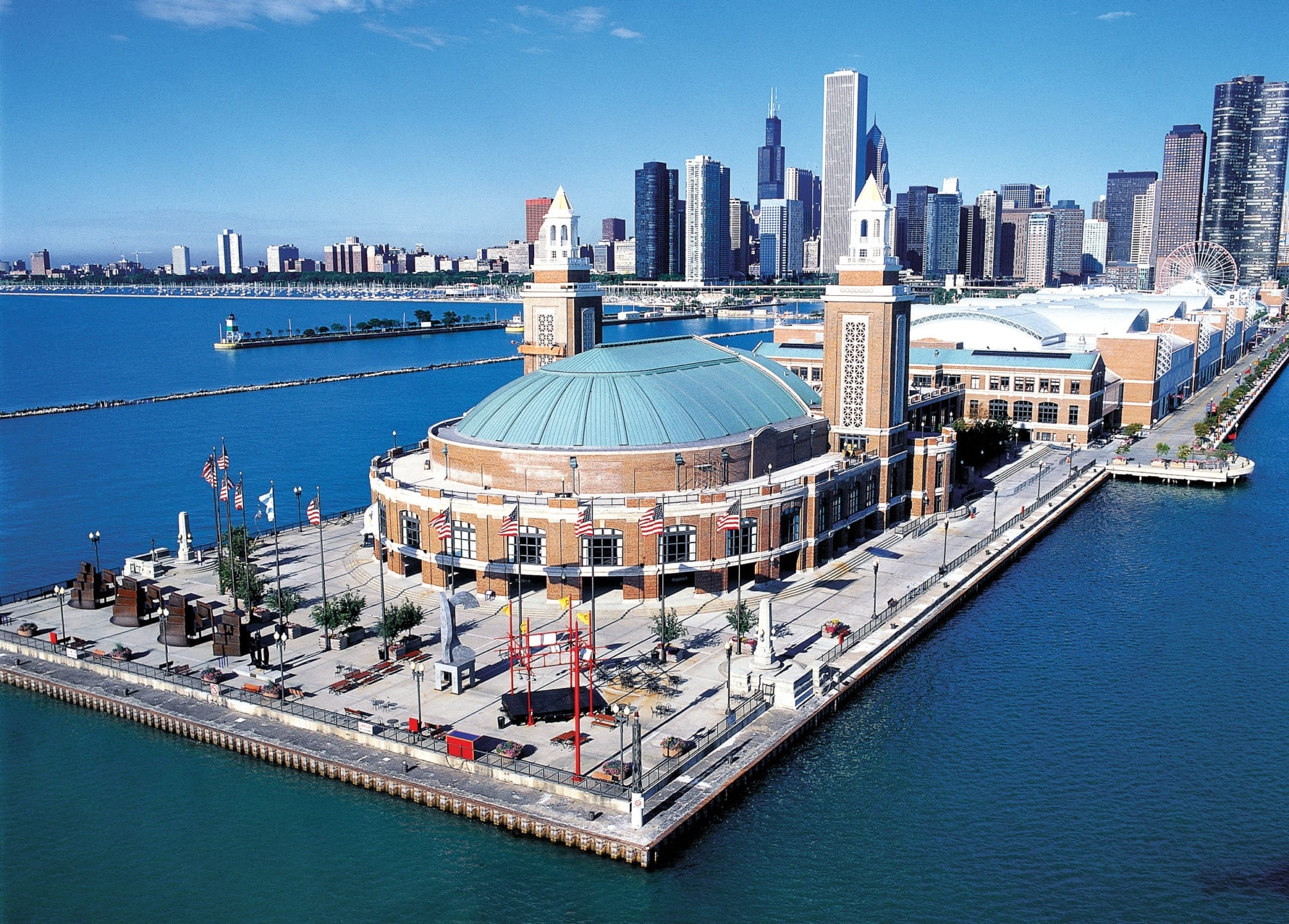 Aerial view of Navy Pier with Chicago skyline in the background and clear blue skies