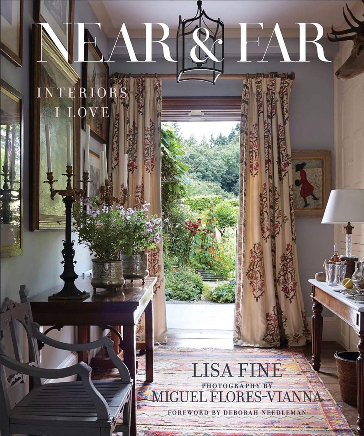 Cover of the book "Near & Far: Interiors I Love" by Lisa Fine, featuring a cozy room with ornate curtains and garden view