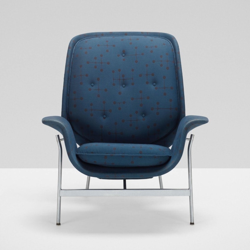 Blue modern armchair with a high back and metal frame against a white background