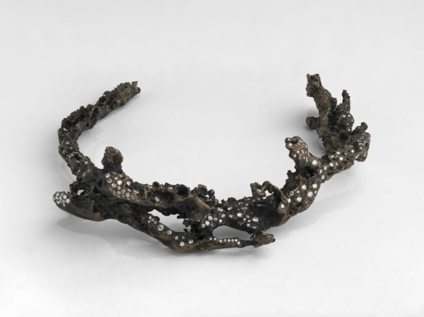 Bronze and diamond tiara with a coral-like design on a plain gray background.