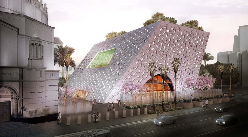 Modern architectural building with geometric facade and greenery, surrounded by palm trees and city street.