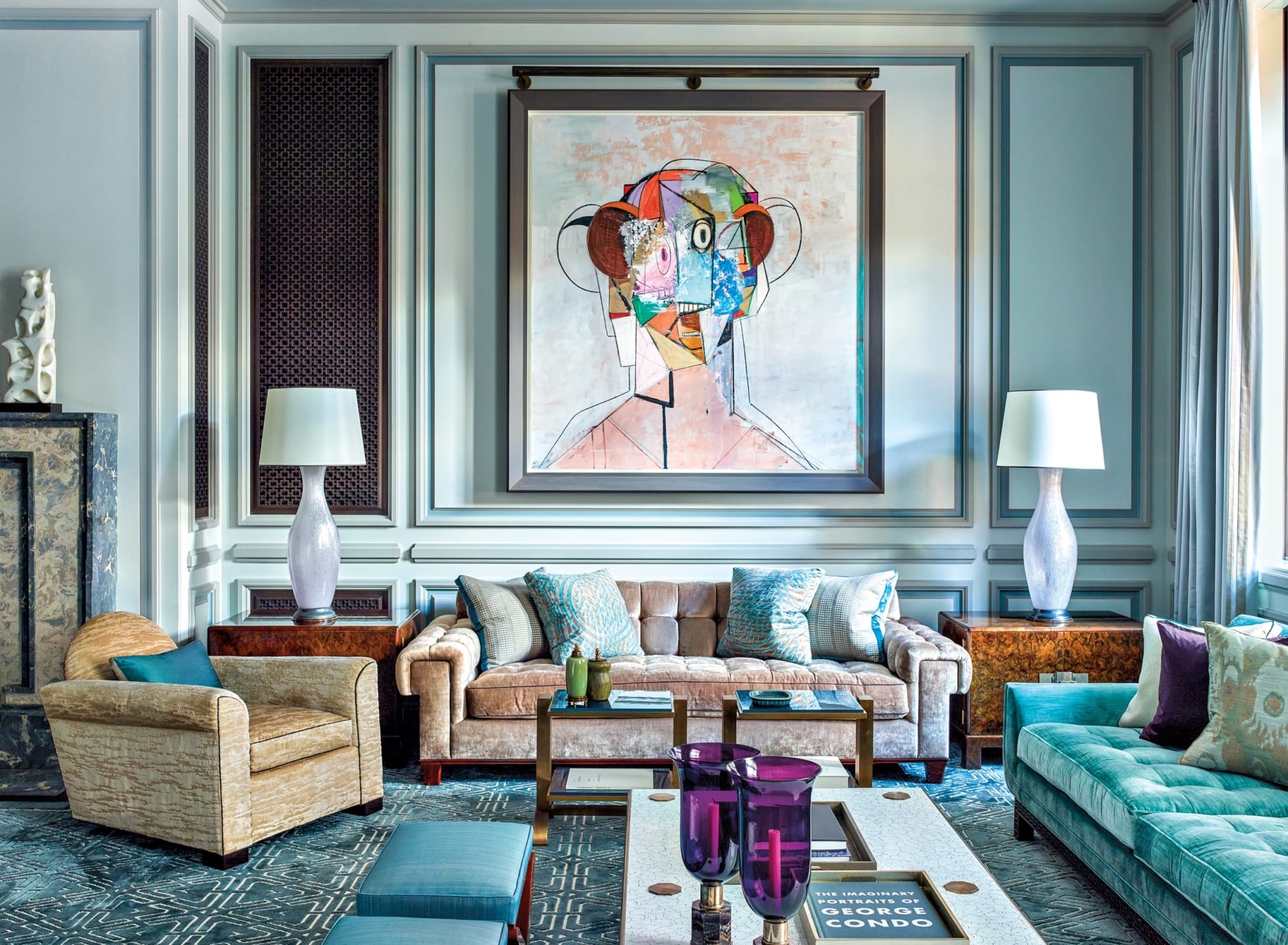 Stylish living room with eclectic art, plush sofas, lamps, and modern decor elements creating a cozy and vibrant atmosphere.