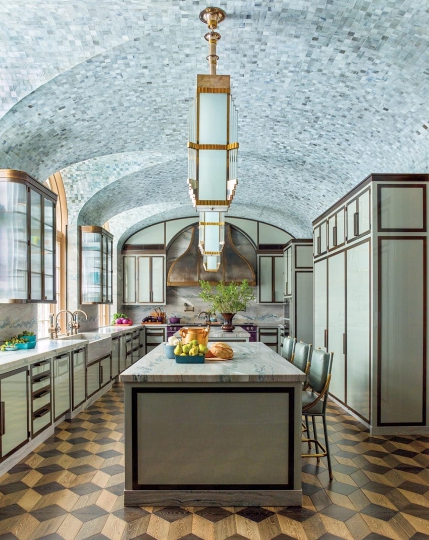 Elegant kitchen with mosaic ceiling, geometric flooring, central island, modern lighting, and abundant natural light.