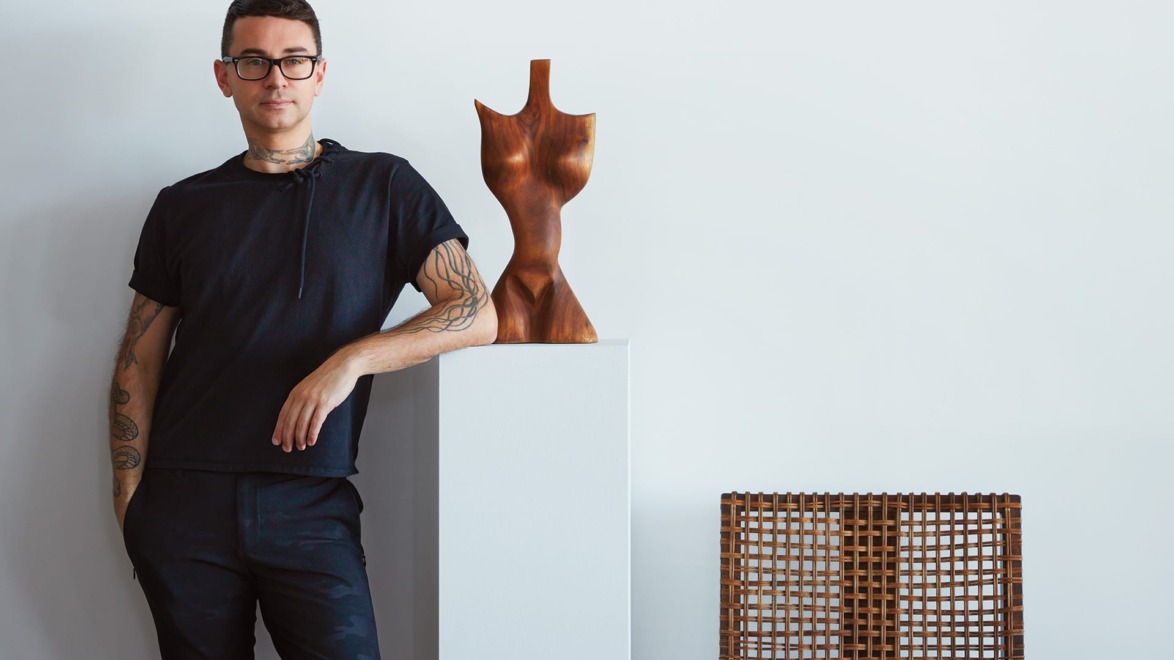 Designer Christian Siriano with a sculpture by an unknown artist.